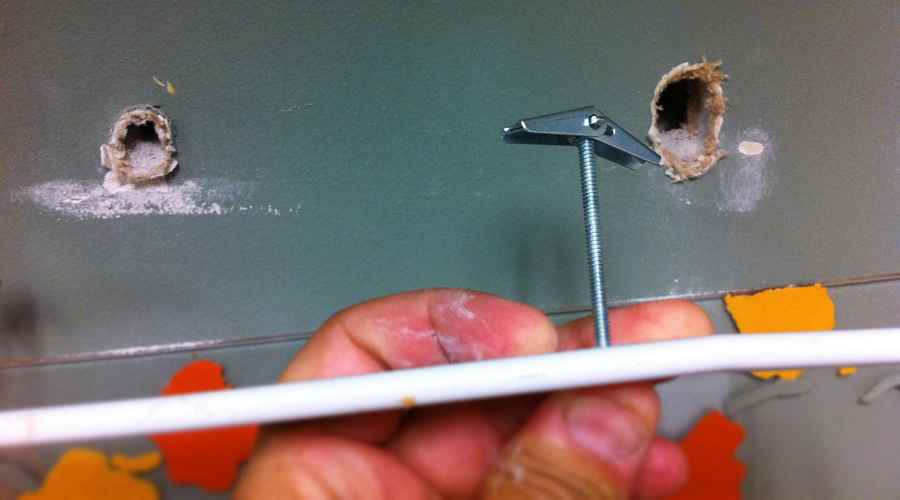 Paper towel holder fix showing toggle bolts