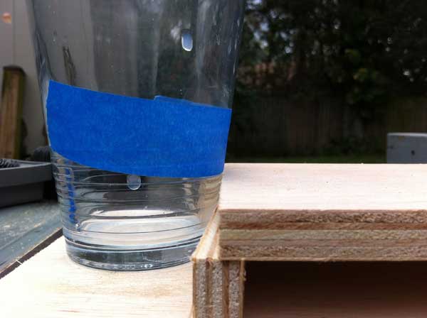 Here's my super-technical way to determine the depth of the glass and then find the radius of the cupholder.