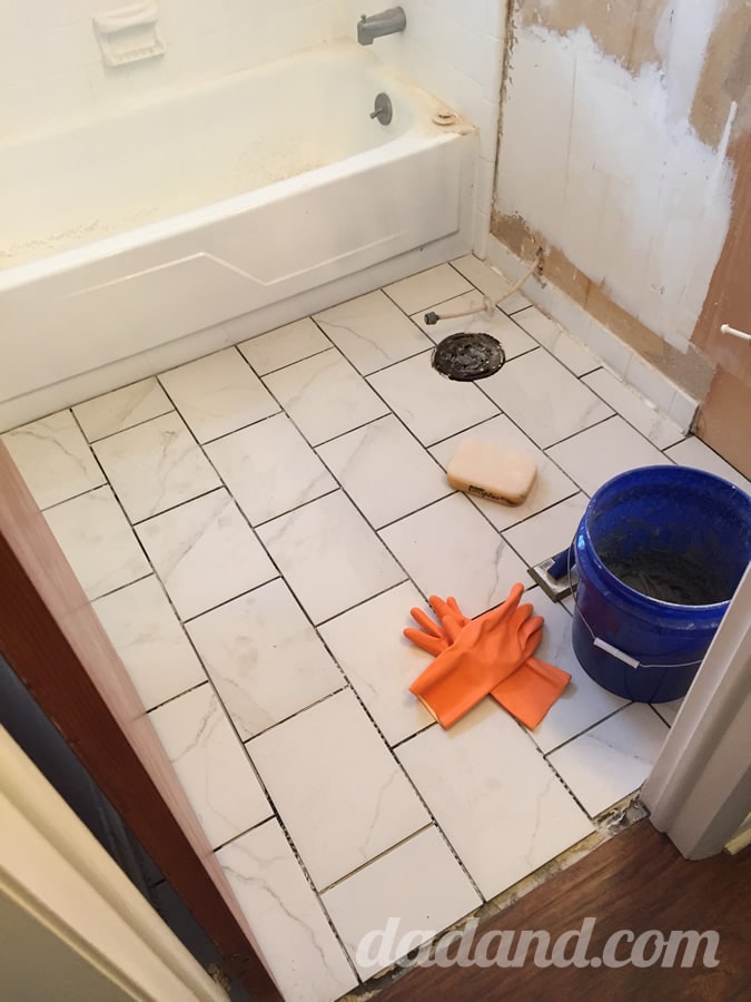 I started early on Day 5 by applying a sanded epoxy grout in a light gray color.